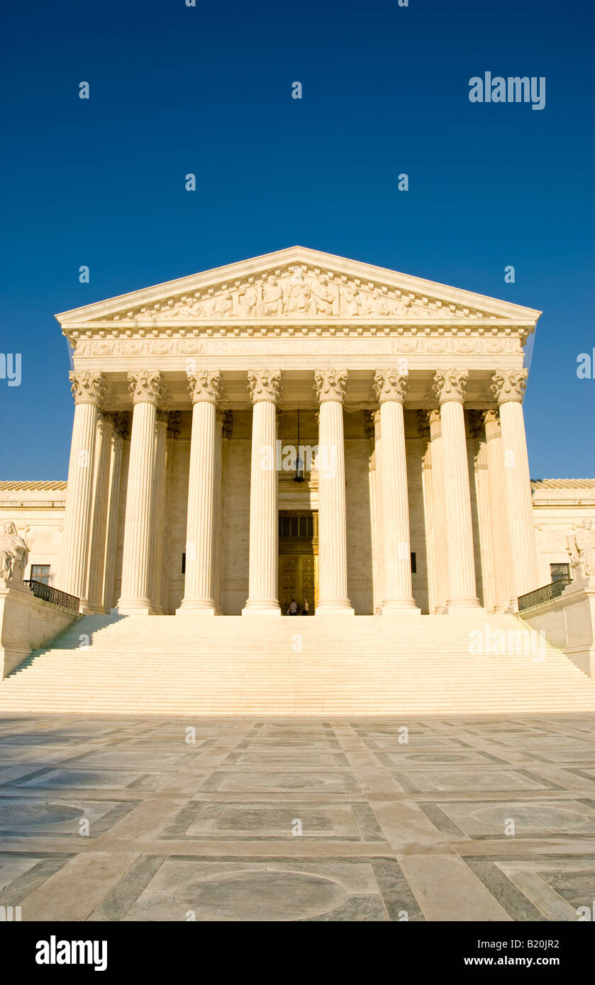 US Supreme Court Building Facade Washington DC // WASHINGTON DC — The US Supreme Court building, located on Capitol Hill in Washington DC, is an iconic example of neoclassical architecture designed by architect Cass Gilbert and completed in 1935. The building's grand facade features 16 towering Corinthian columns and a marble staircase leading to the entrance. Inscribed above the main entrance are the words 'Equal Justice Under Law,' reflecting the Court's constitutional mission. The building serves as the highest judicial authority in the United States and is a major landmark in the nation's  Stock Photo
