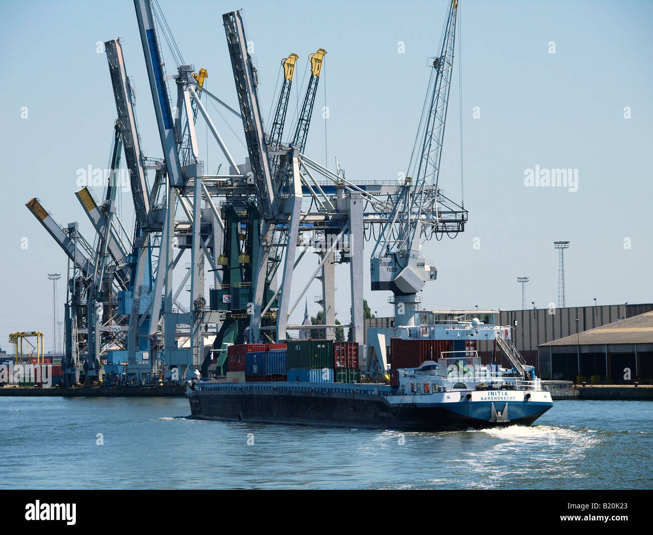 Dutch barge loaded with containers sailing through the seaport of Antwerp Belgium Stock Photo