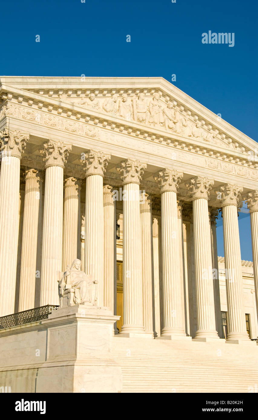 United States Supreme Court Building Contemplation Of Justice Statue Washington DC // WASHINGTON, D.C. — The western facade of the United States Supreme Court Building features the iconic 'Contemplation of Justice' statue at the lower left, created by sculptor James Earle Fraser in 1935. Above rises the ornate pediment, designed by Robert Aitken, depicting 'Equal Justice Under Law' with allegorical figures representing Order, Authority, and Liberty. The neoclassical building, completed in 1935, serves as the permanent home of the nation's highest court after the justices previously met within  Stock Photo