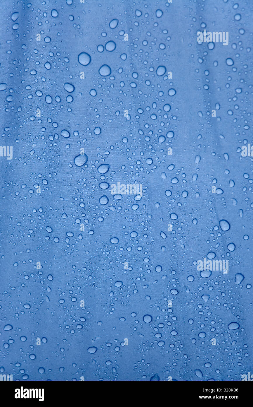 Close up of rainwater droplets on the surface of a blue tent Stock Photo