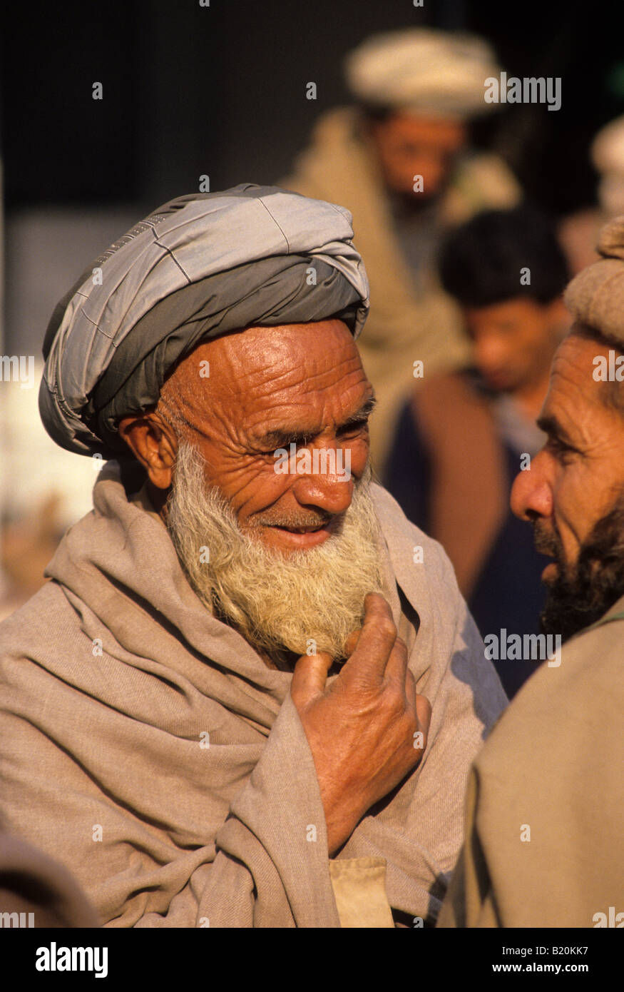 Two Pashtun men gather in the gun making town of Darra Adam Khel Pakistan Stock Photo