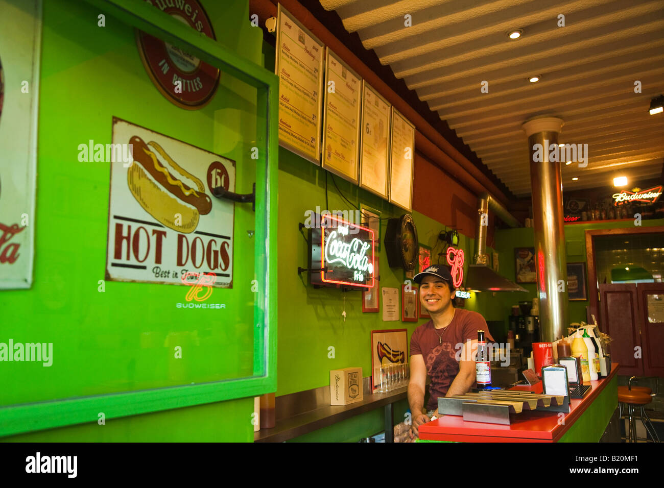 SPAIN Madrid Sign for Chicago hot dogs restaurant waiter sit behind counter Stock Photo