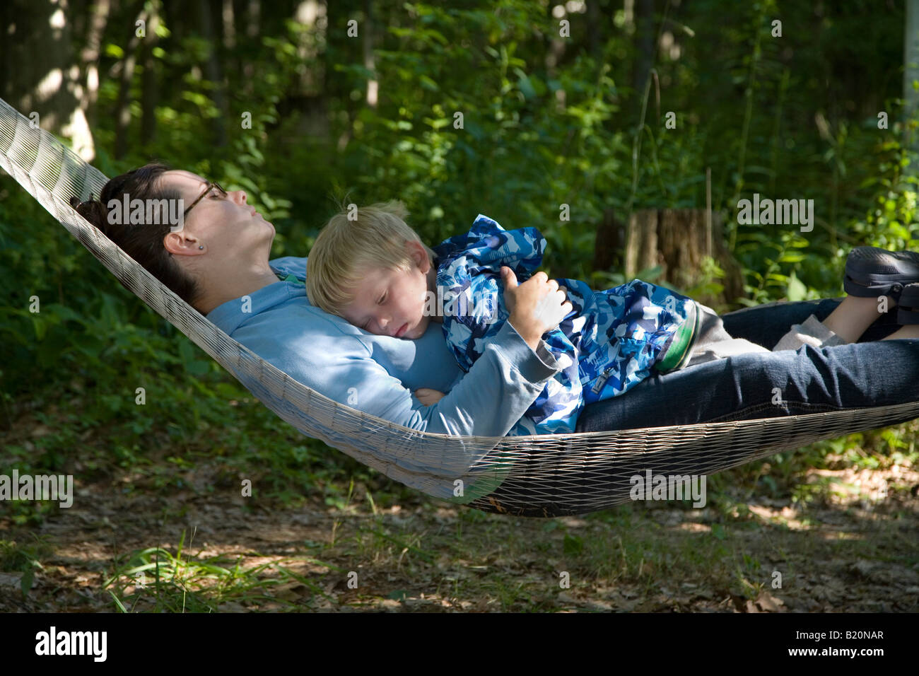 Prairieville Michigan A two year old boy sleeps with his mother on a hammock Stock Photo