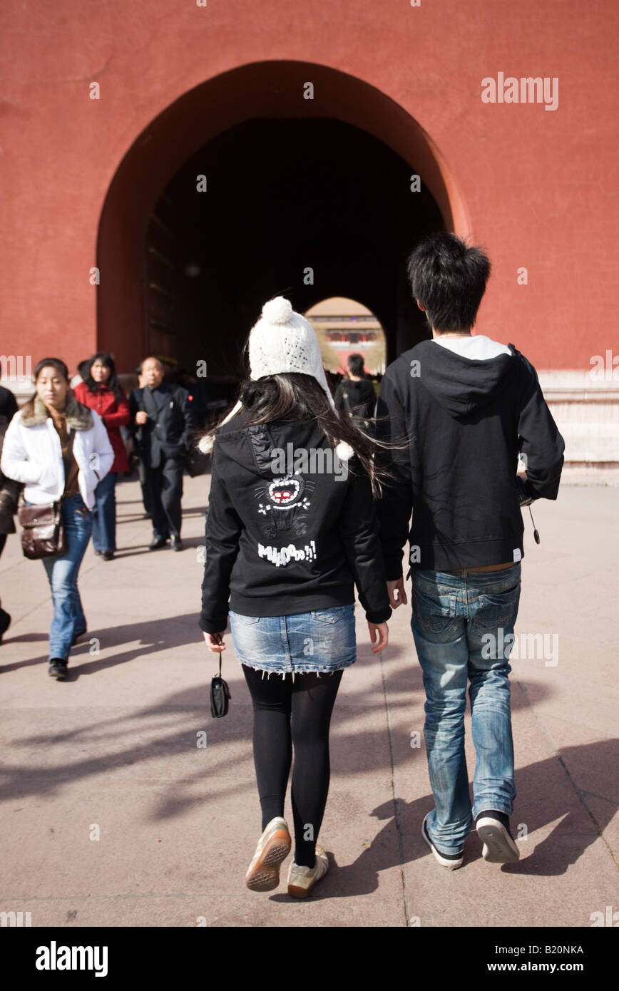 Young Chinese couple in modern western clothing at the Forbidden City entrance Beijing China Stock Photo