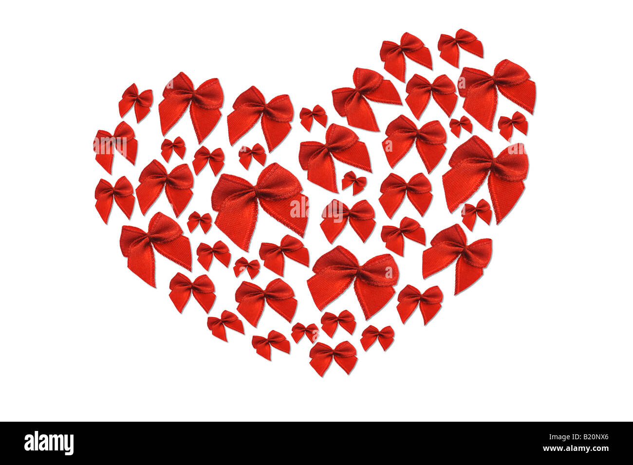 Red decorative bows arranged in heart shape symbol on white background Stock Photo