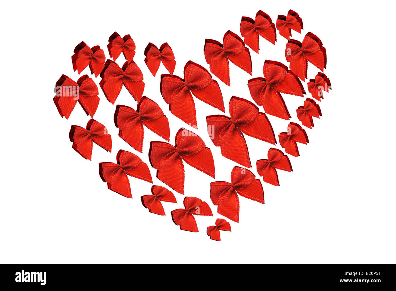 Red decorative bows arranged in heart shape symbol on white background Stock Photo