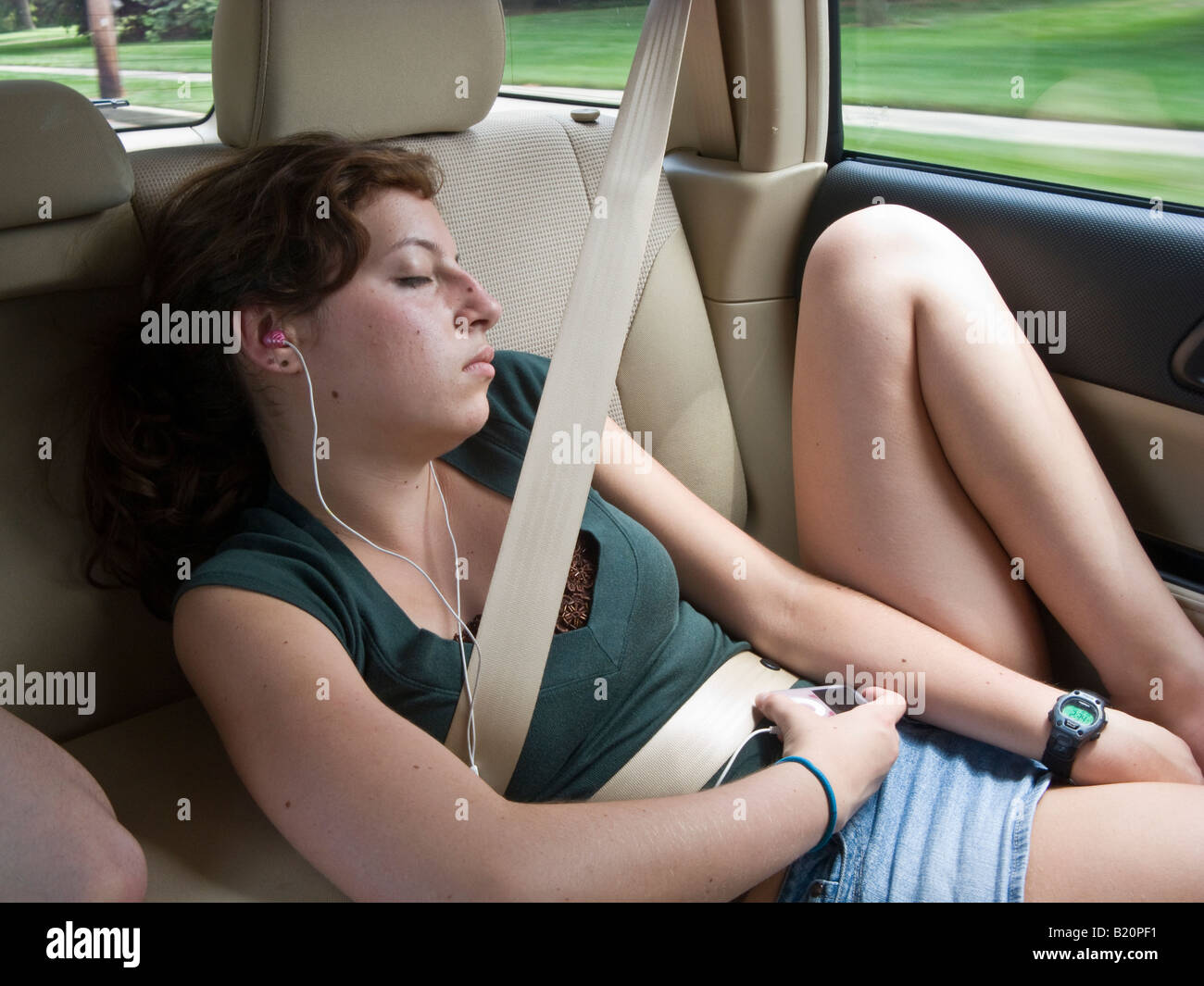 15 year old teenage girl sleeping in car Stock Photo