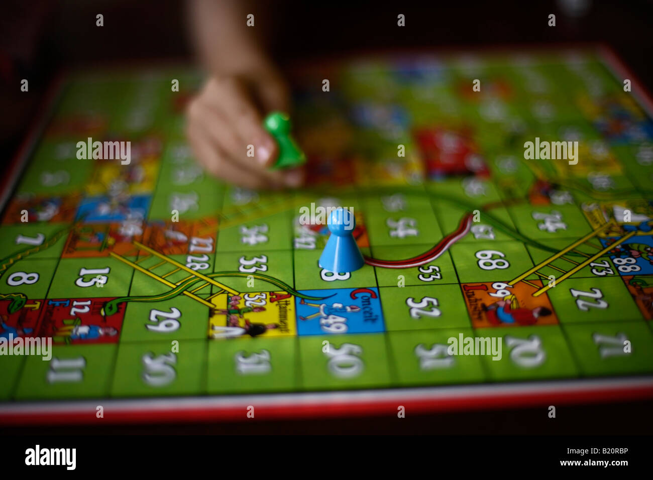 Children play game of snakes and ladders Stock Photo Alamy