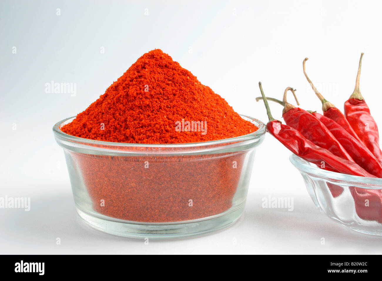 Glass bowl full of Red Chili Powder, with Red Chili in a bowl Stock