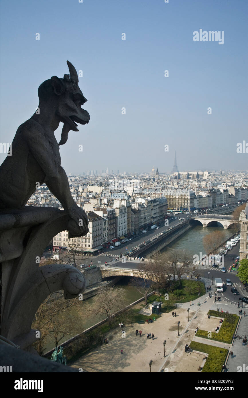 Notre Dame Cathedral gargoyles on exterior with scenic panoramic view over Paris in spring sunshine France Europe EU Stock Photo