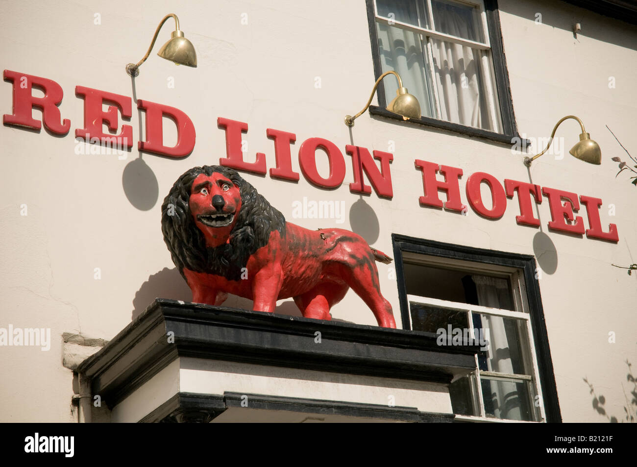Carved wooden painted effigy of a lion outside the Red Lion Hotel Llanidloes Powys Wales UK Stock Photo