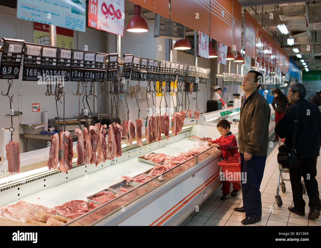 Shoppers at meat counter in supermarket in Chongqing Sichuan Province China Stock Photo