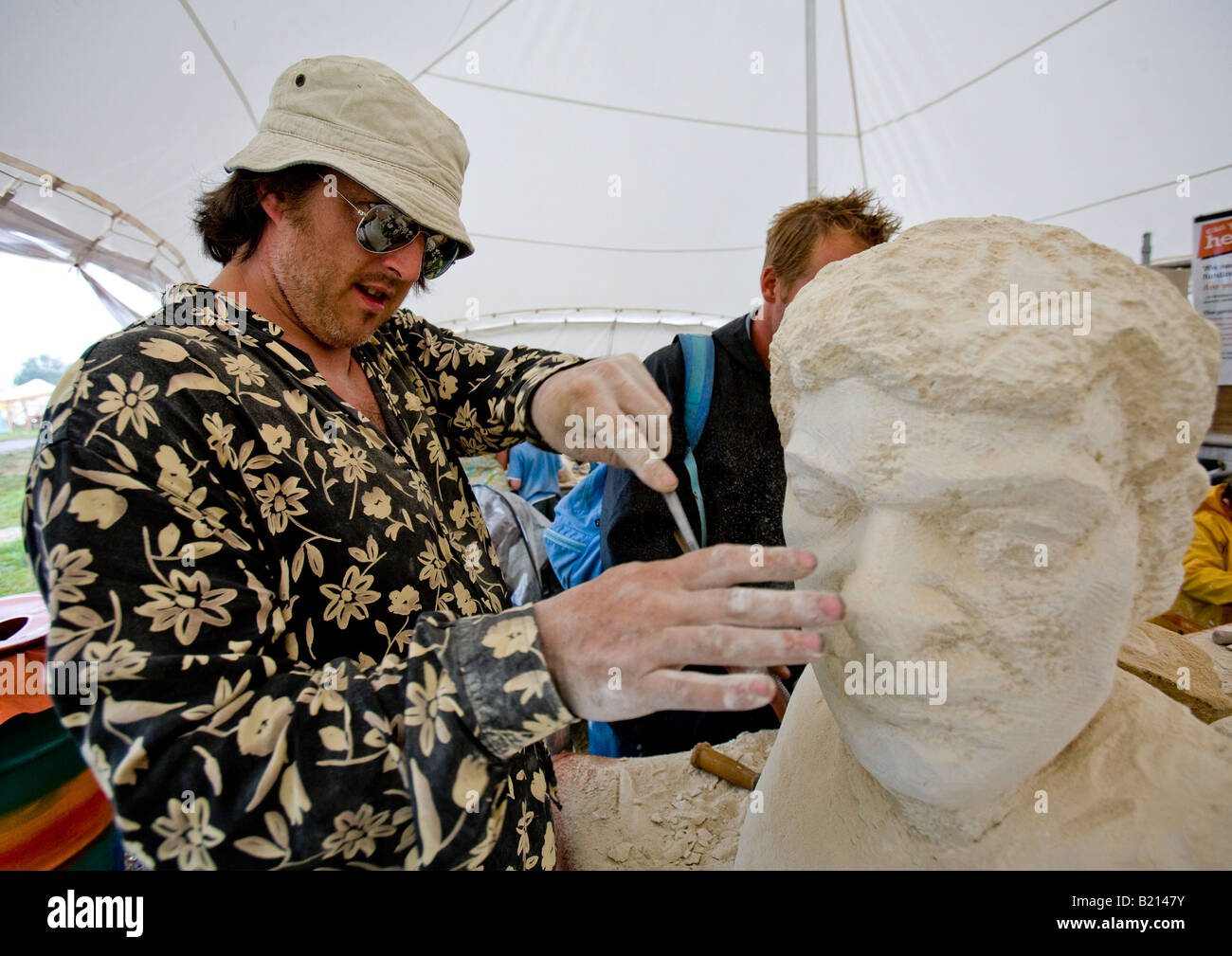 Man Carving Sculpture At Glastonbury Festival Pilton Somerset UK Europe Stock Photo