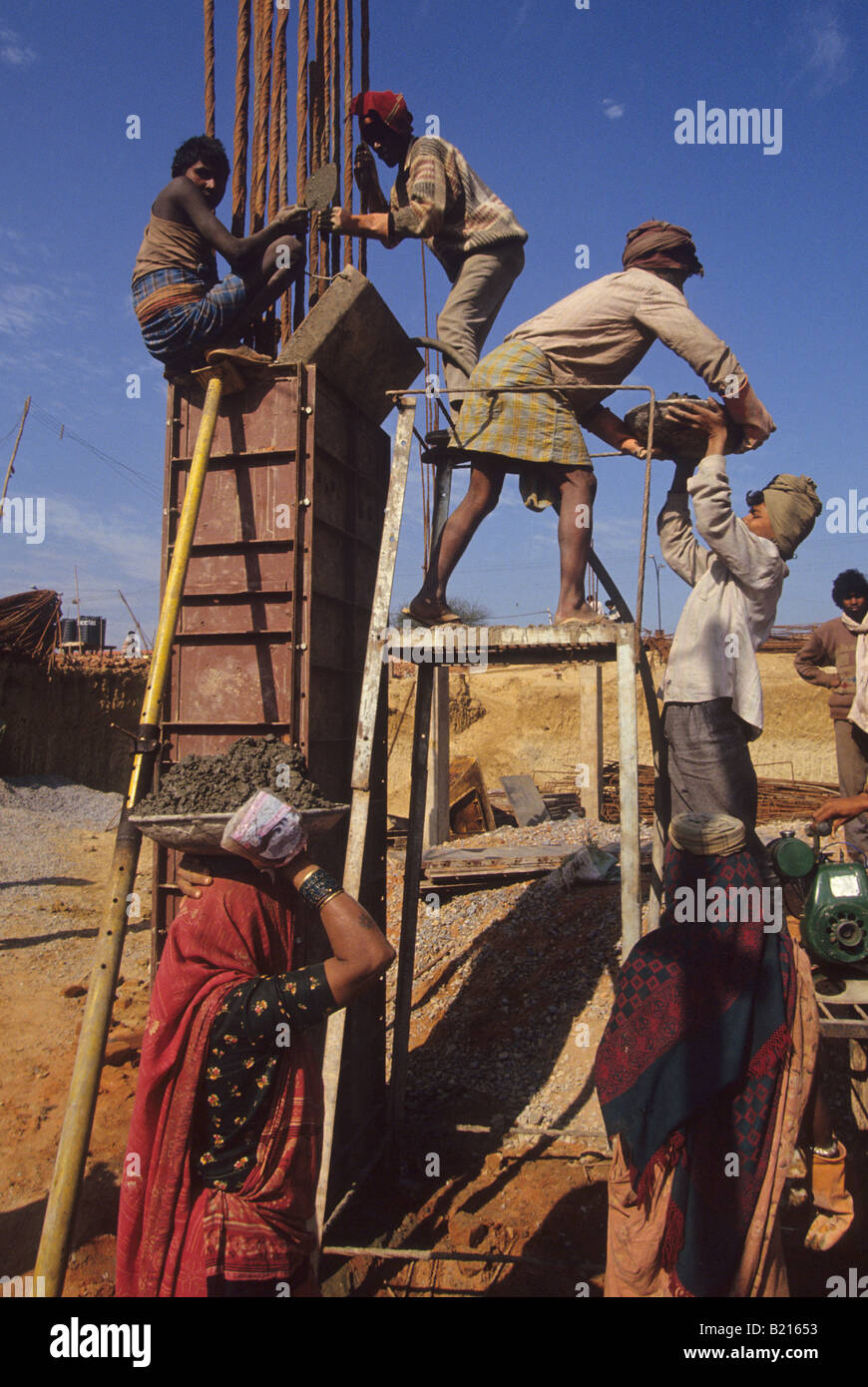 Indian men and women work at a construction site in New Delhi India