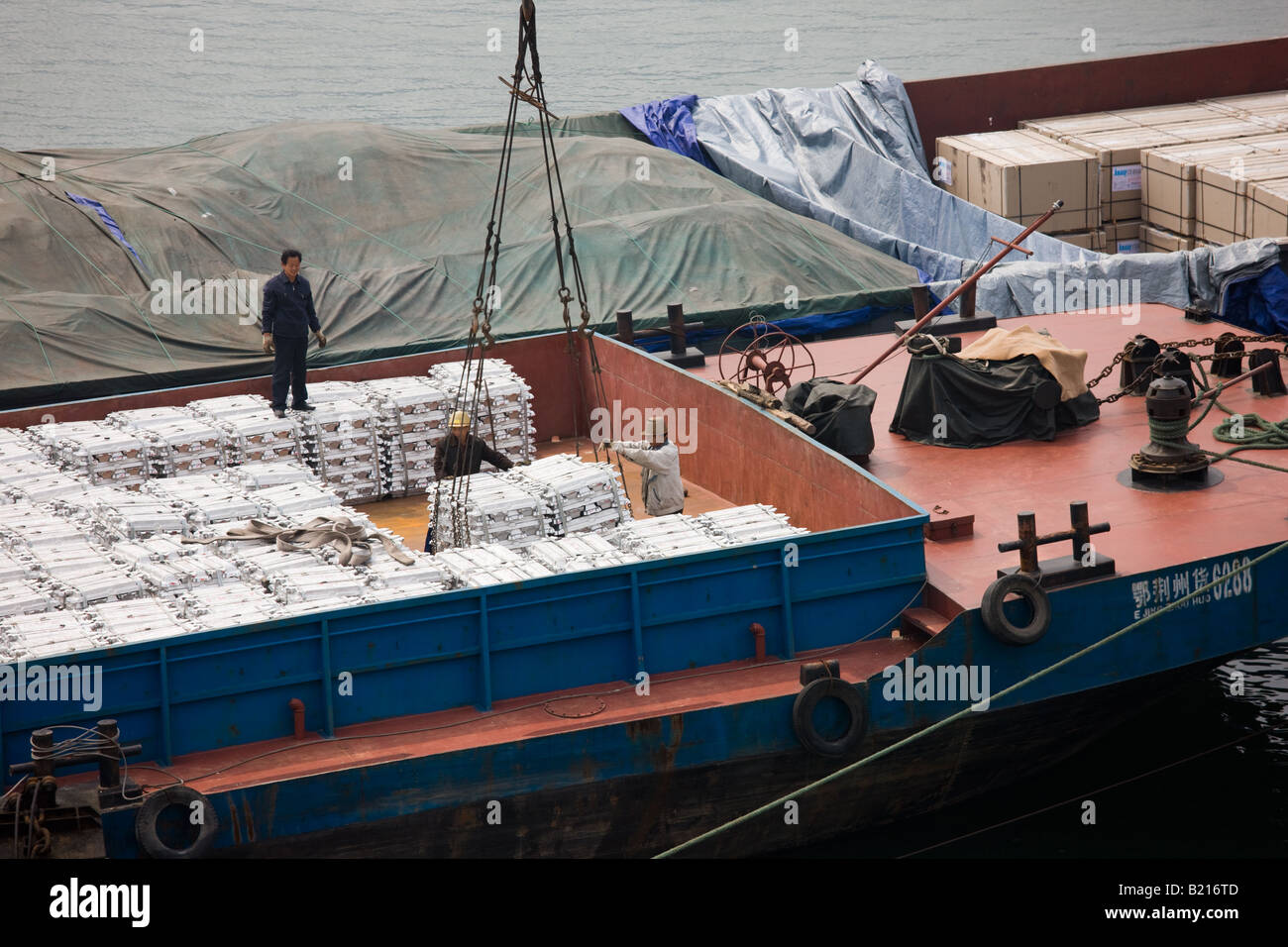 Aluminim ingot blocks being loaded onto cargo ship Yichang China Stock Photo