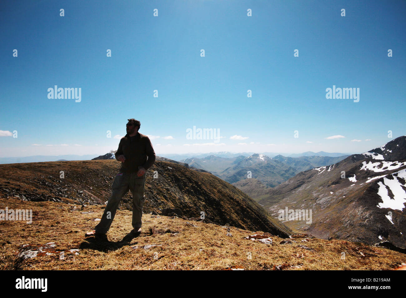 man at summit of mountain Stock Photo