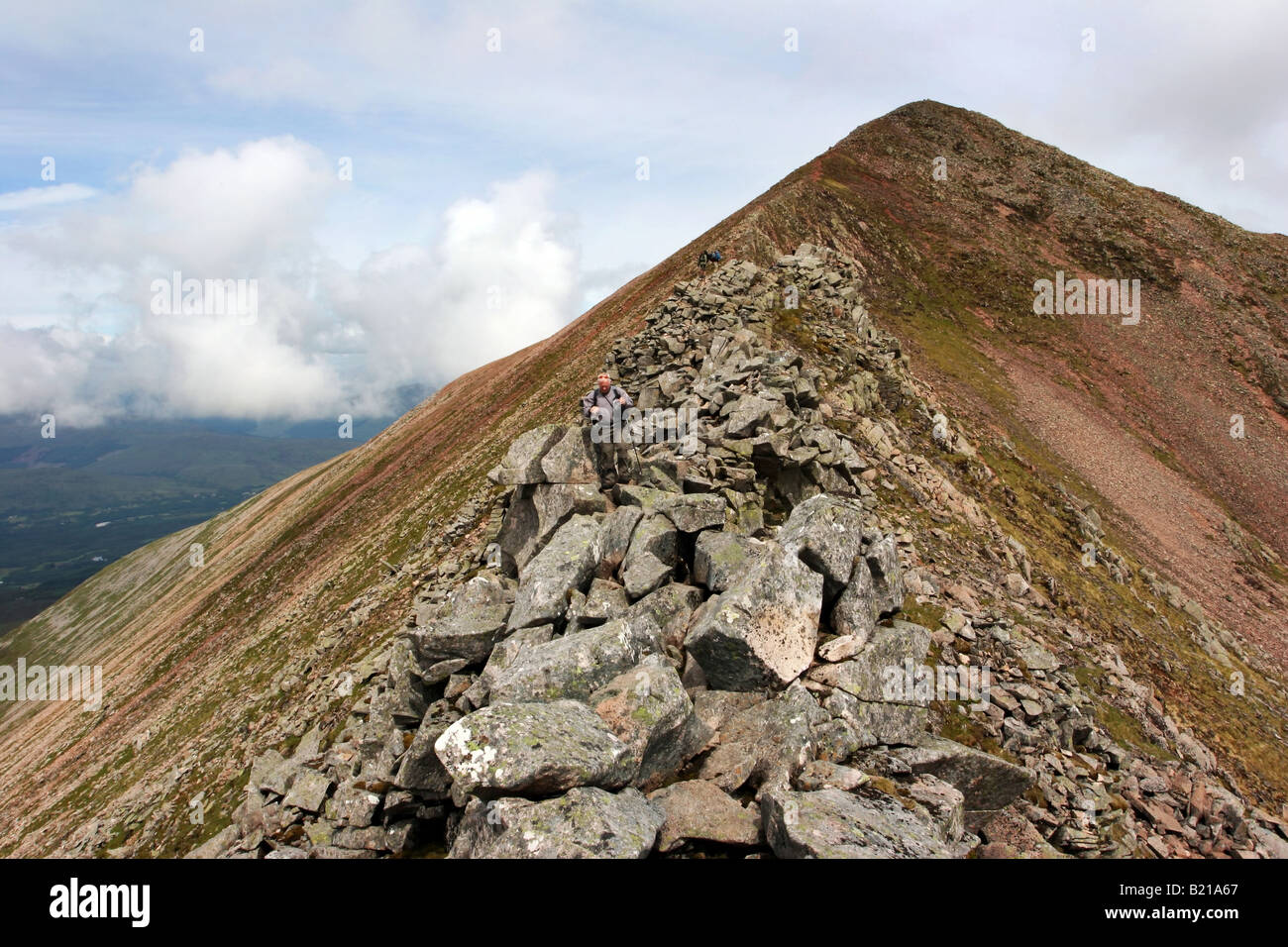 Hiker descending the CMD Arete from Carn More Dearg enroute to Ben Nevis Stock Photo