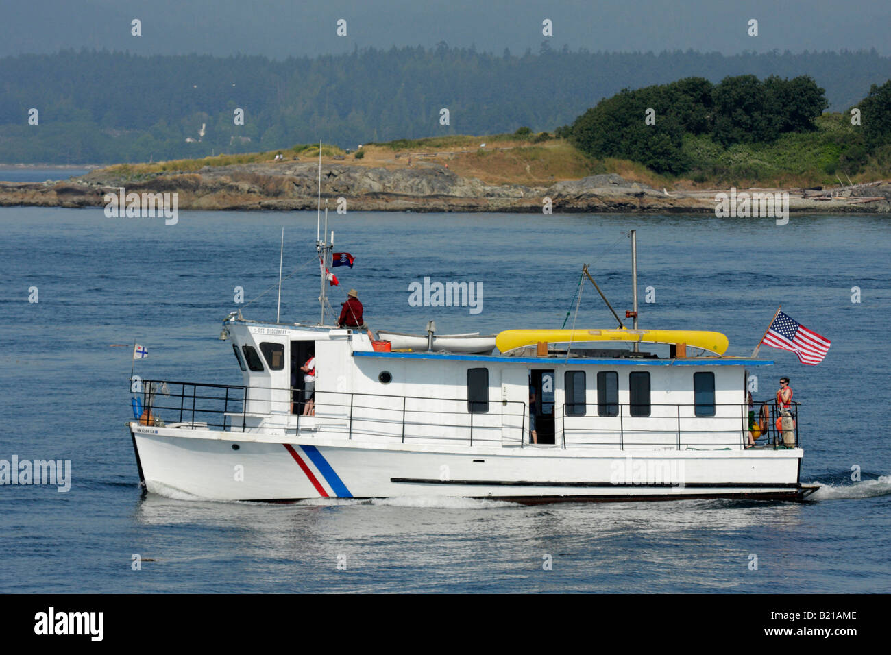 Small houseboat cruising in Juan de Fuca Strait Victoria British Columbia Canada Stock Photo