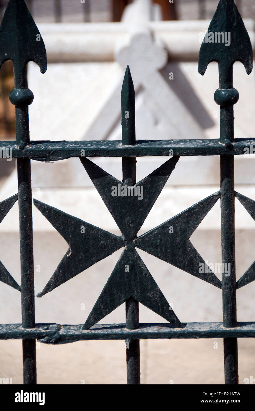 A maltese cross design in wrought iron fence in Upper Barrakka Gardens