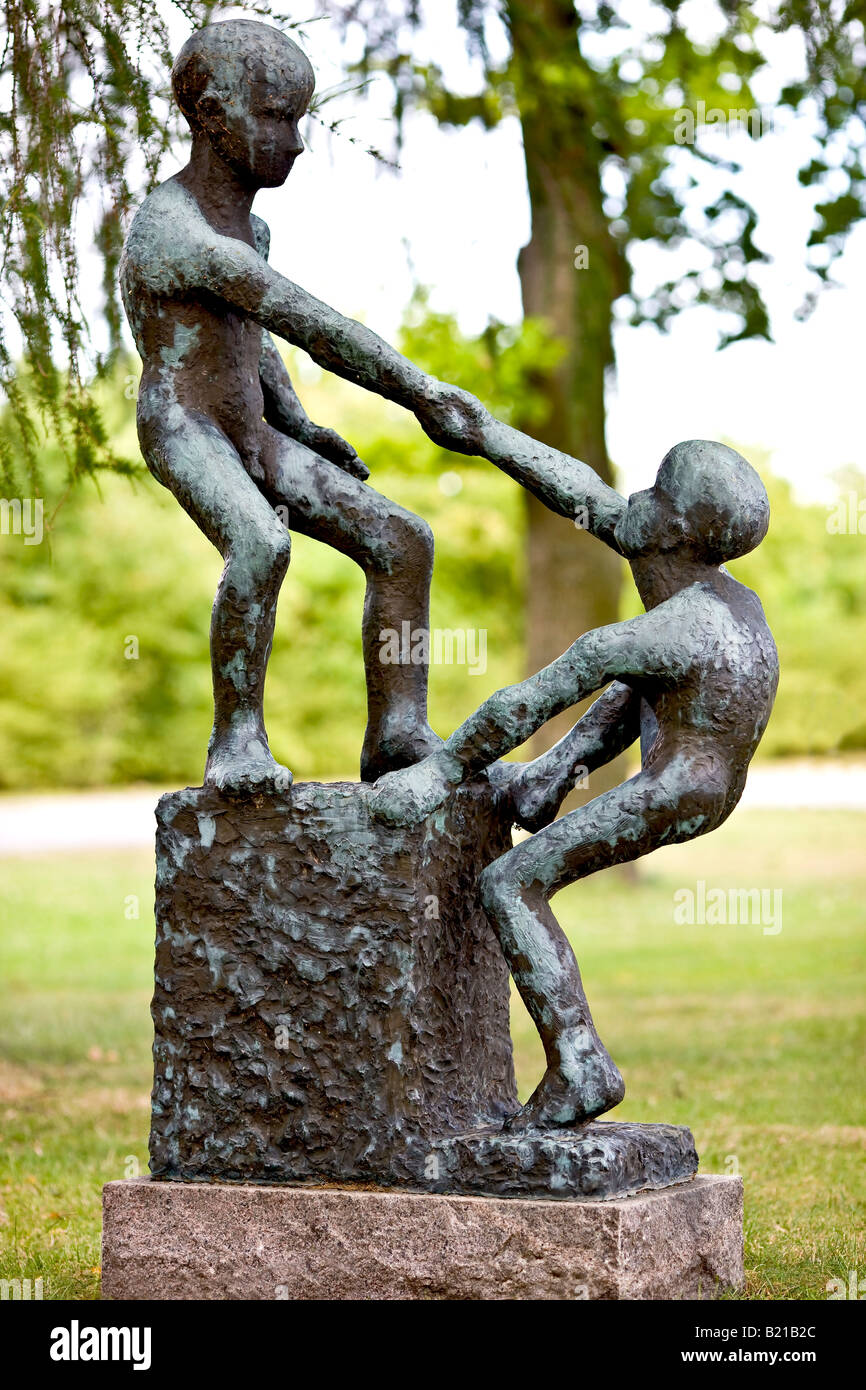 Sculpture of two boys that help each other Stock Photo