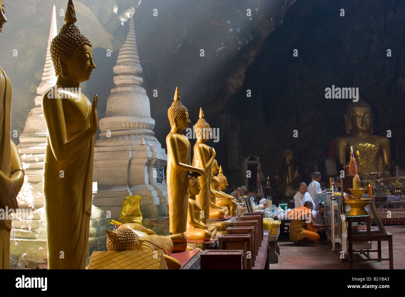 Buddha statues and pagoda inside underground cave temple Khao Luang