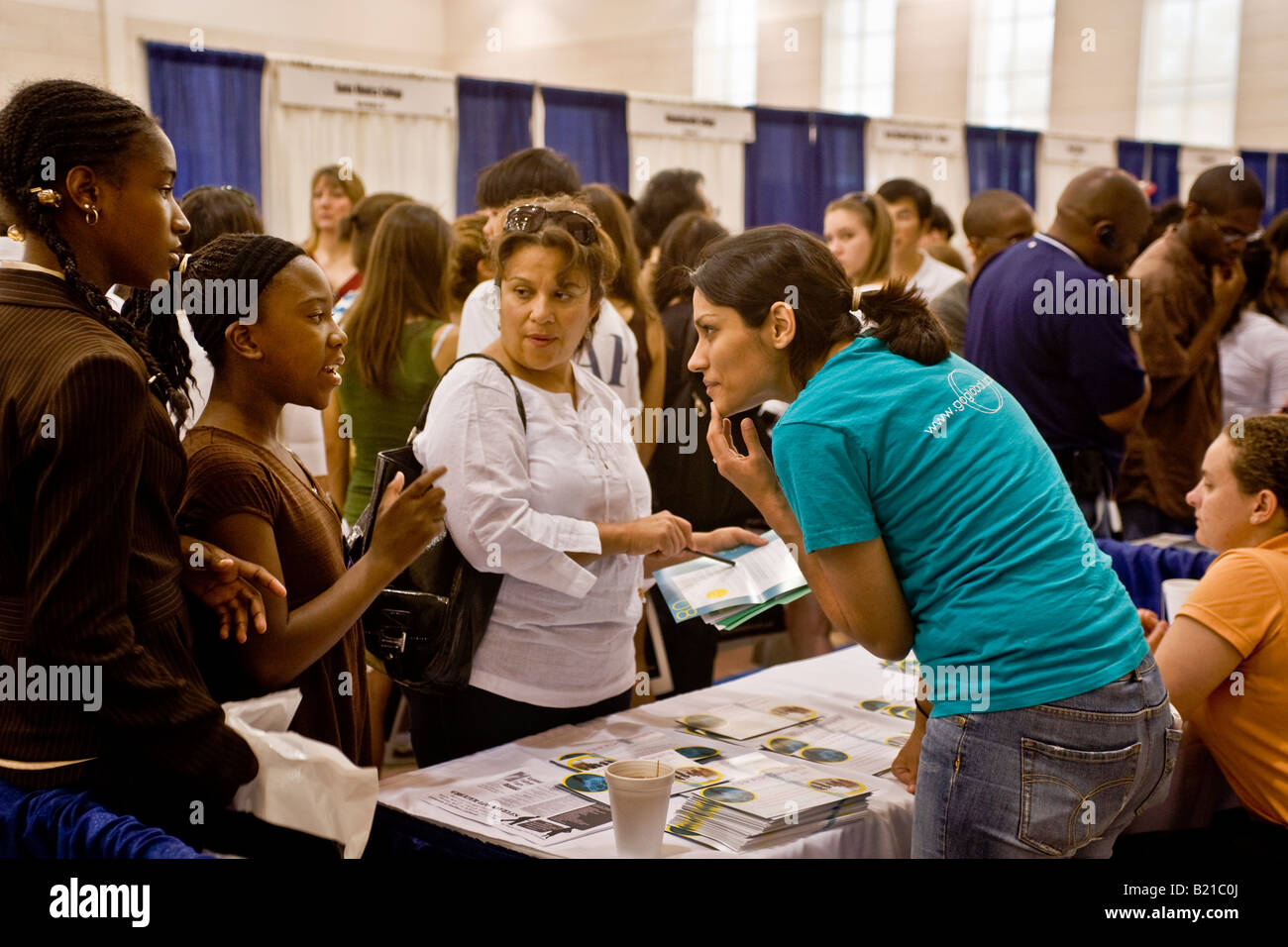 A college representative advises high school students at a college fair in Los Angeles Stock Photo