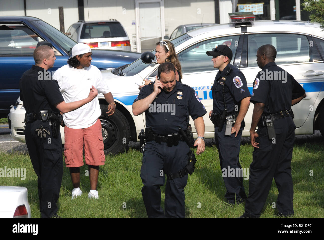 Police question a Latino man and a woman at a crime scene in College Park, Maryland Stock Photo