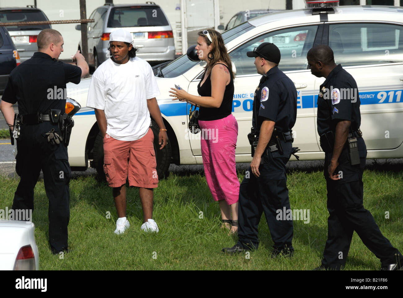 police confront a Latino man and a woman at a crime scene in College Park. Md Stock Photo