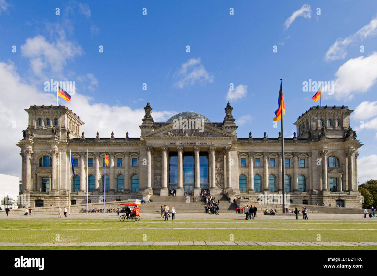 A wide angle view of the Reichstag (German Parliment Building) and tourists on a sunny day. Stock Photo