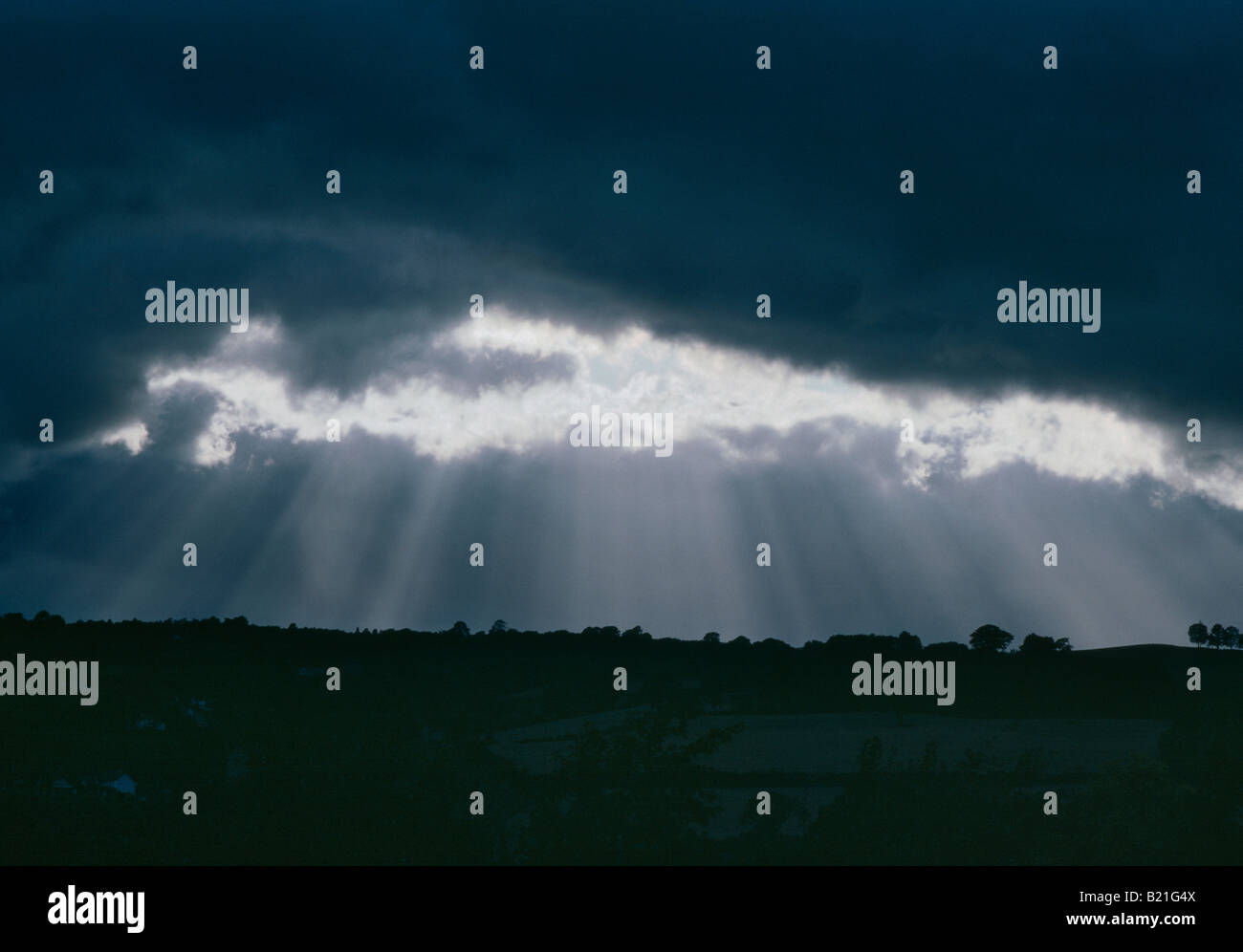 BREAK IN STORM CLOUDS WITH SHAFTS OF LIGHT Stock Photo