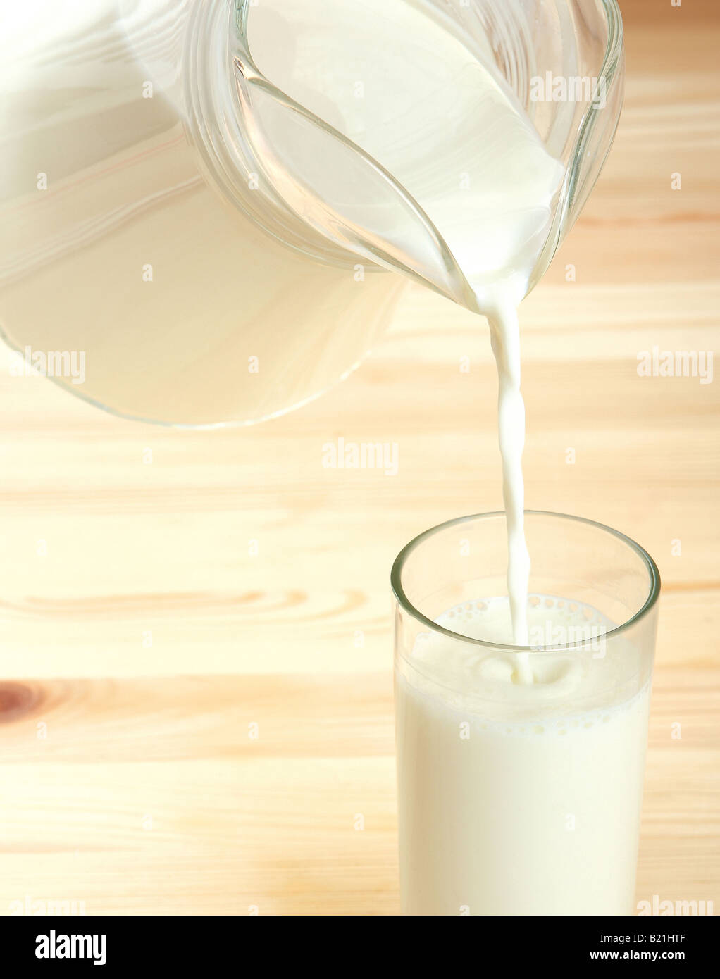Milk being poured from a glass jug Stock Photo Alamy