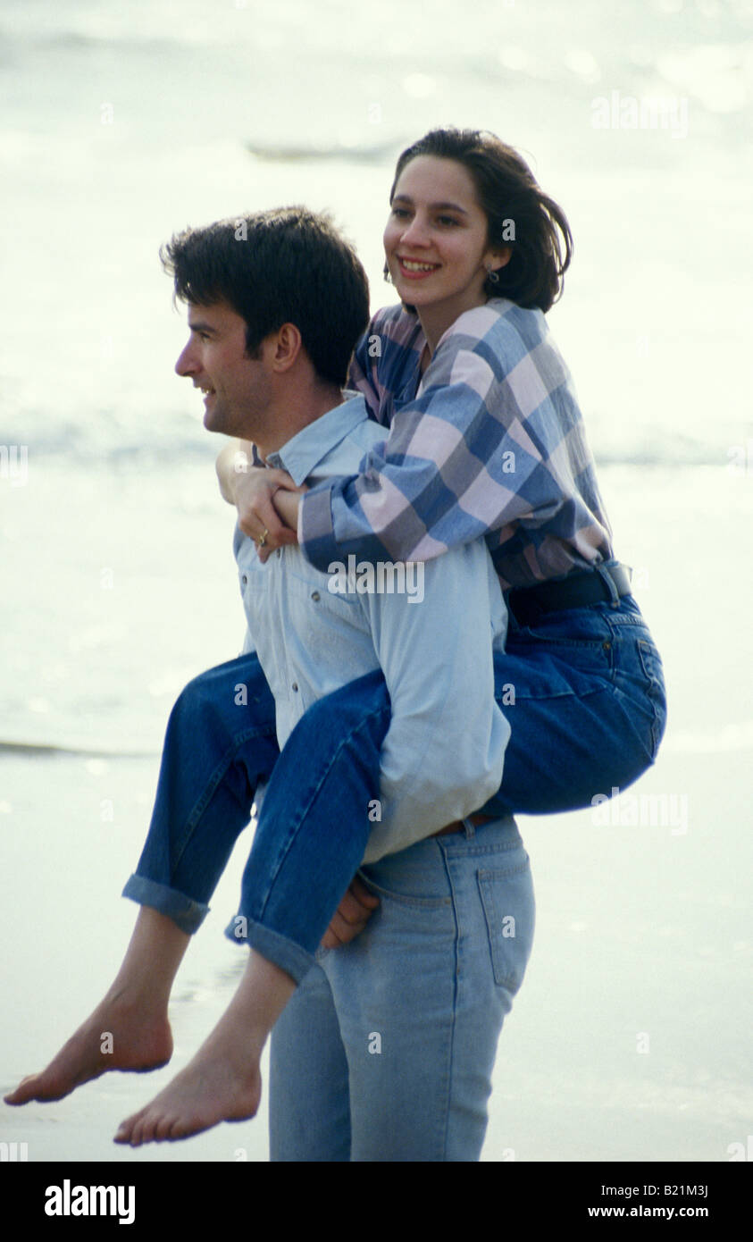 Young couple on the beach girlfriend having piggyback Stock Photo - Alamy