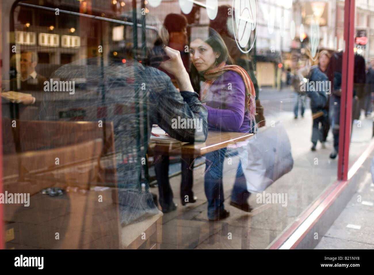 Shoppers stop for a coffee in London Stock Photo