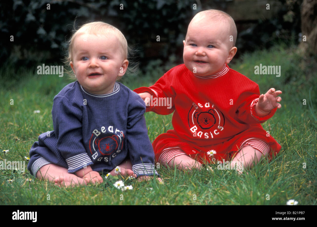 portrait non identical boy and girl twin babies Stock Photo