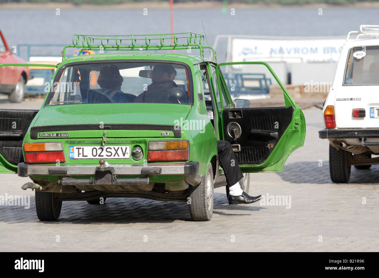 A man steps out from his old Dacia car in front of ferry in Galati