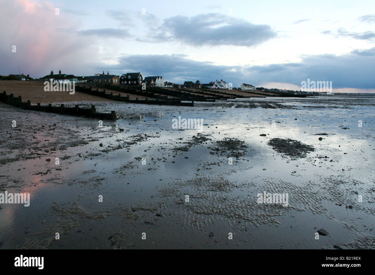View from the beach at low tide at dusk of Whitstable, Kent, England. Stock Photo