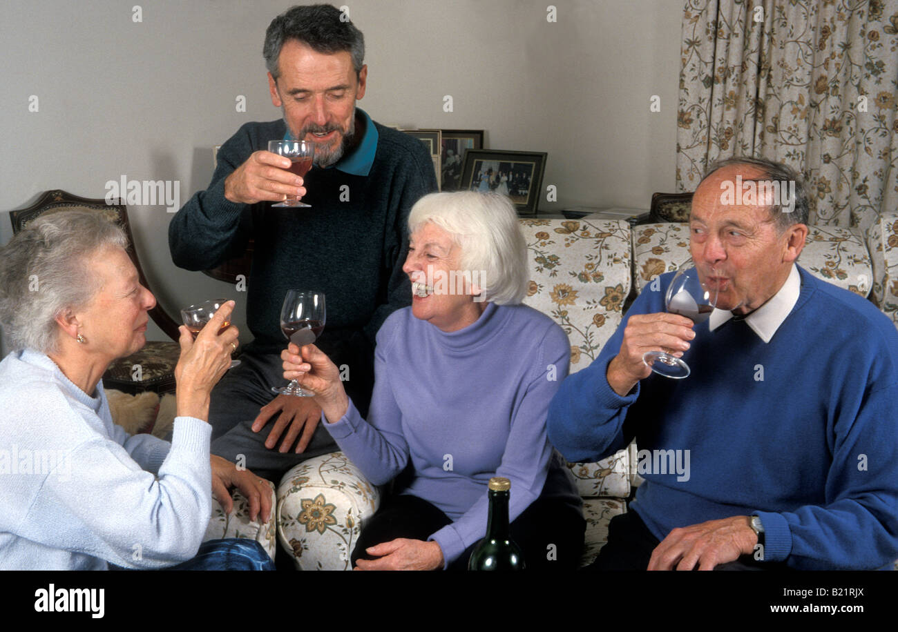 group of seniors having party and drinking wine Stock Photo