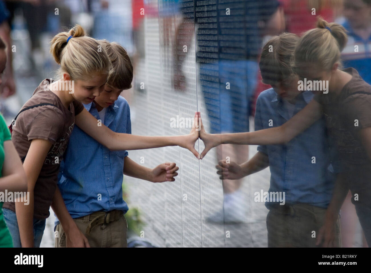 Children touch and examine the Vietnam War Memorial in Washington D C on June 13th 2006 Stock Photo