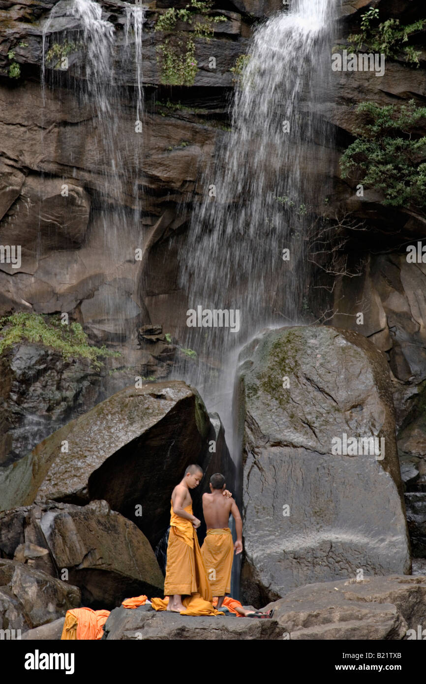 Young Buddhist monks bathe in Tad Puk waterfall, Attapeu, Laos Stock