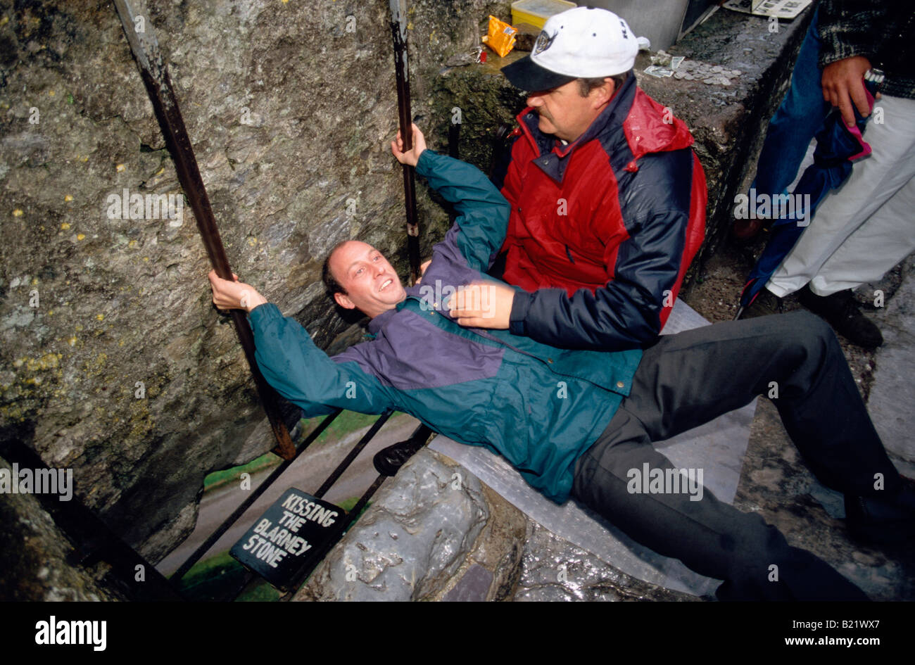 Tourists kissing the Blarney stone Blarney castle County Cork Ireland