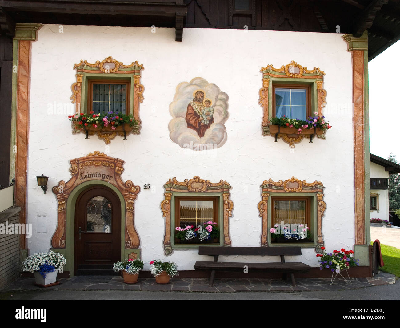 A traditionally decorated house with hand painted religious themes in Sistrans near Innsbruck Austria Stock Photo