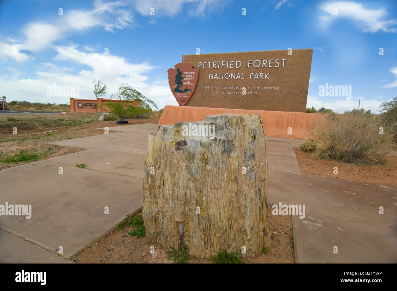 Petrified log in front of Petrified Forest National Park sign Stock Photo