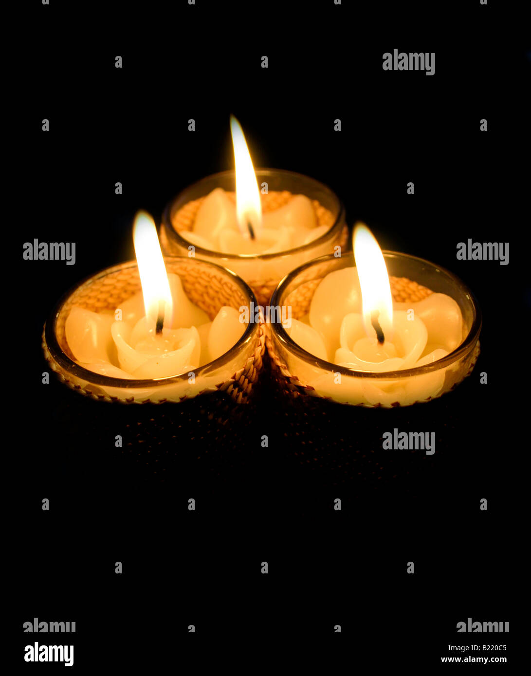 three candles in glass containers Stock Photo Alamy