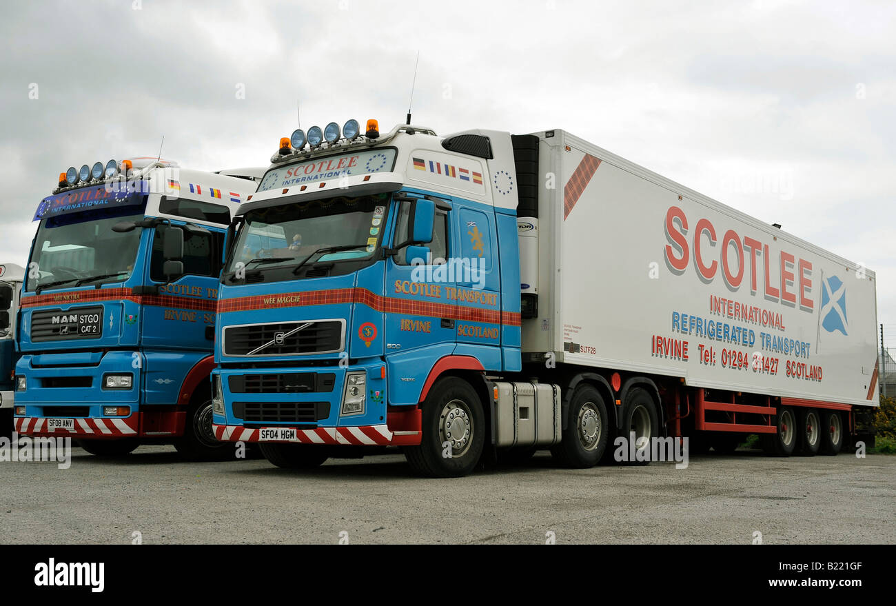 Two modern high roof cabbed trucks A MAN TGA XXL and Volvo FH Globetrotter tractor units with refrigerated trailers Scotlee Tran Stock Photo