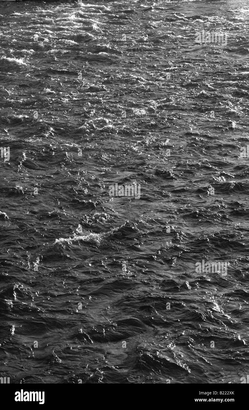 Water flowing down the flooded banks of a river, Quebec winter. Stock Photo