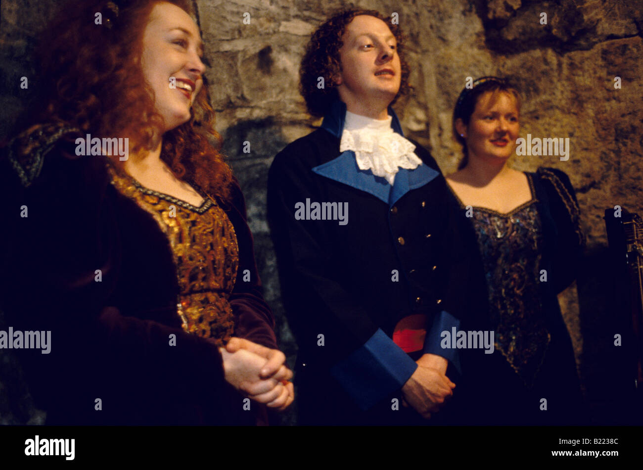 Three women in historic dress at medieval banquet Dunguaire castle ...