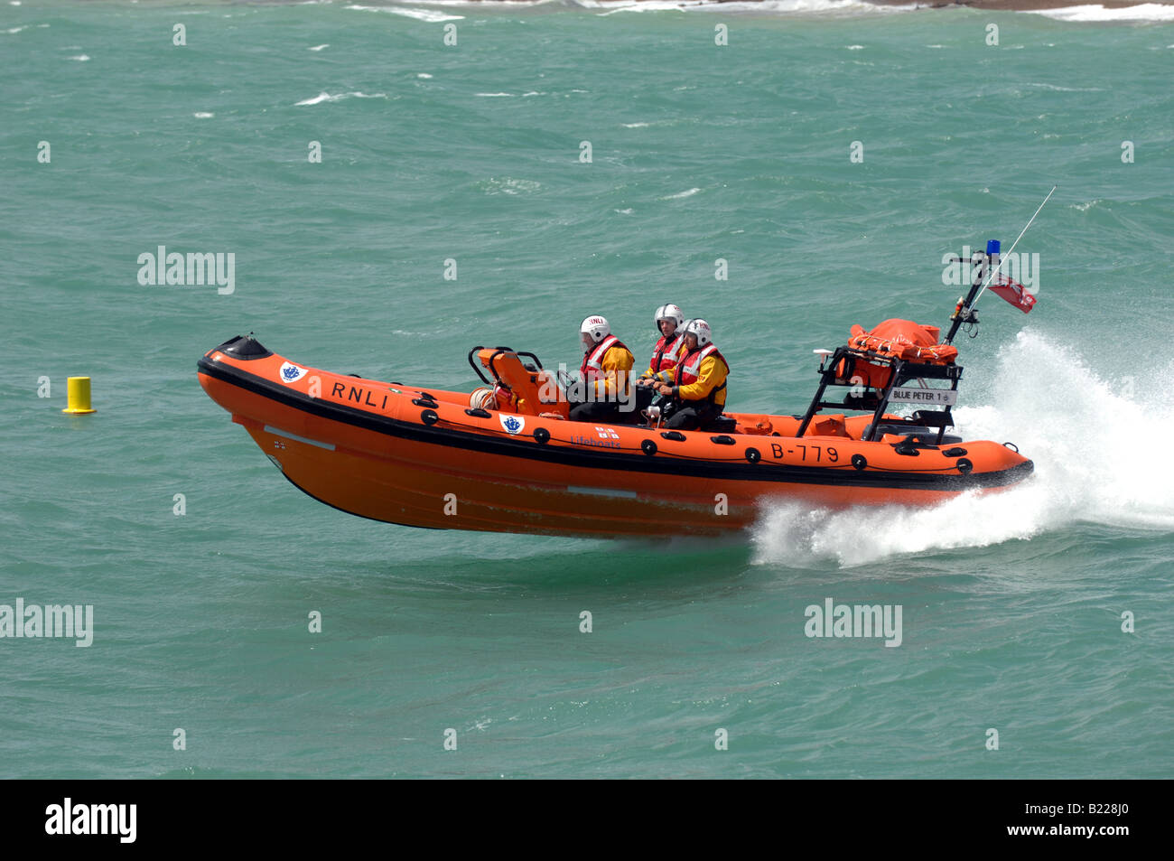 The RNLI inshore lifeboat named Blue Peter 1 in action off Worthing seafront UK Stock Photo