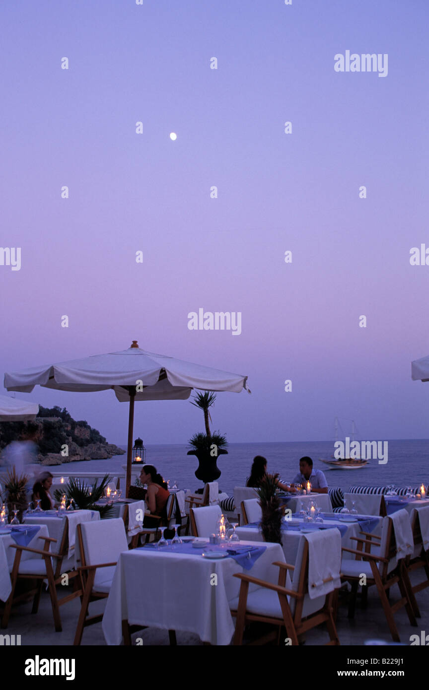 People sitting on terrace of the restaurant Club 29 Antalya view over the marina in the evening Antalya Antalya Turkey Stock Photo