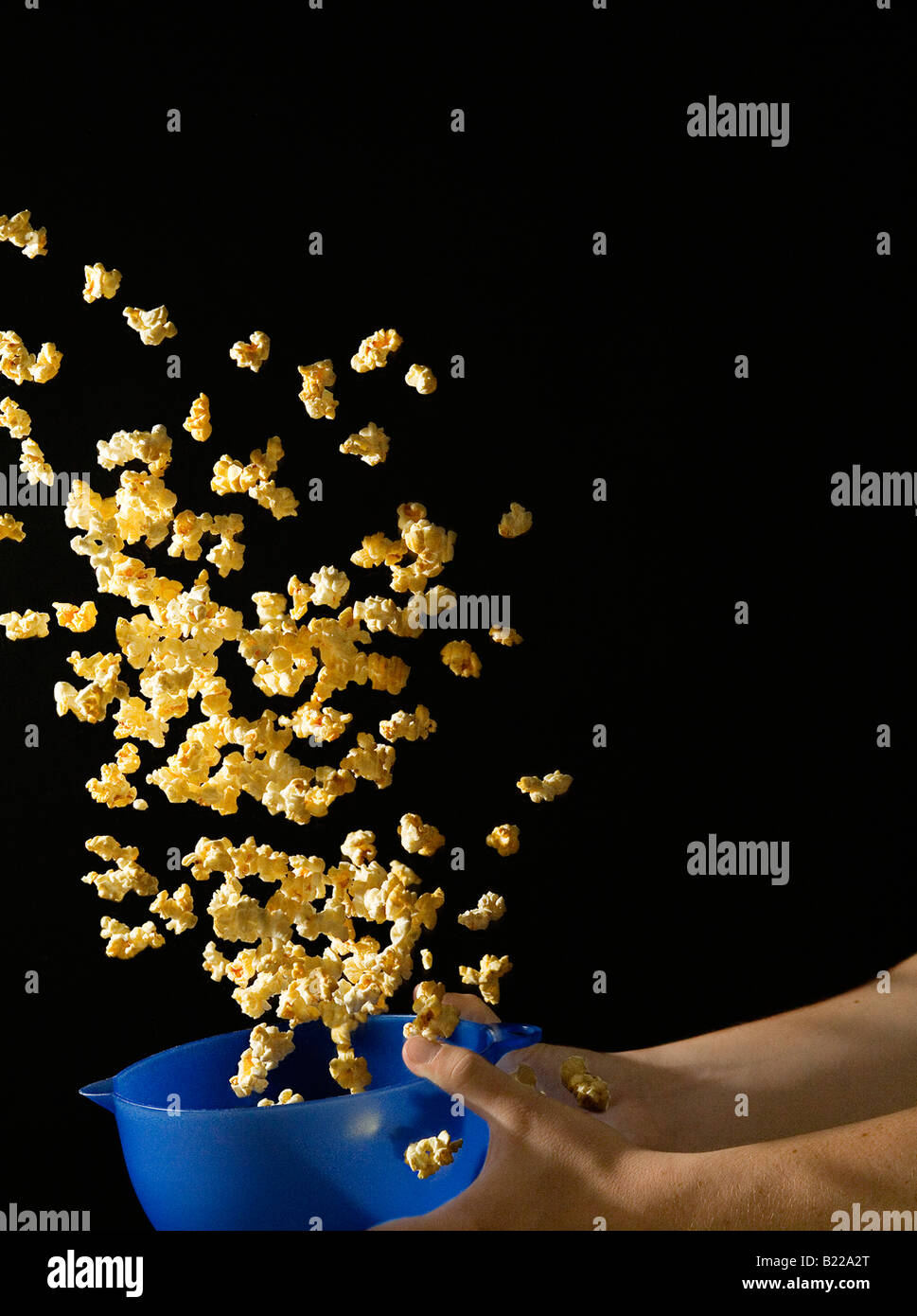 Popcorn Flying out of Bowl Stock Photo