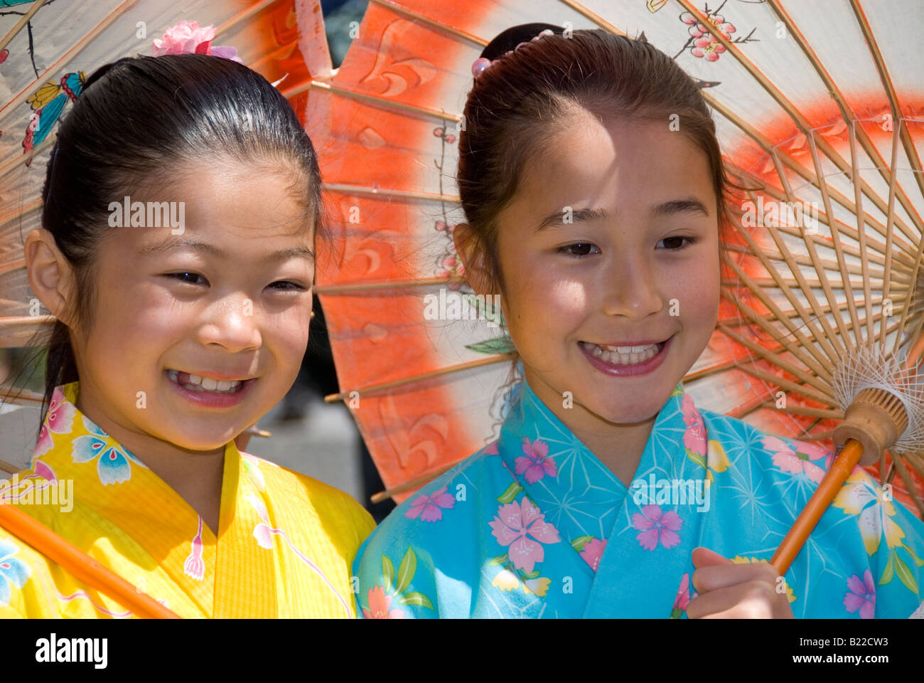 Two Japanese girls in traditional dress with umbrellas at the Cherry Blossom Festival Grand Parade, San Francisco, California Stock Photo